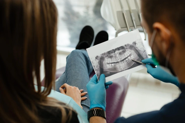Dentist going through with patient her dental X-Ray results.