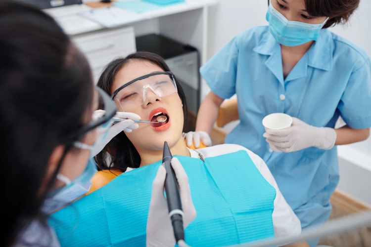 Lady undergoing emergency dental treatment at dental clinic.