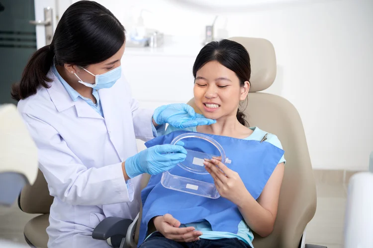 Female dentist explaining dental procedure clearly to female patient to ensure comfort and clarity.