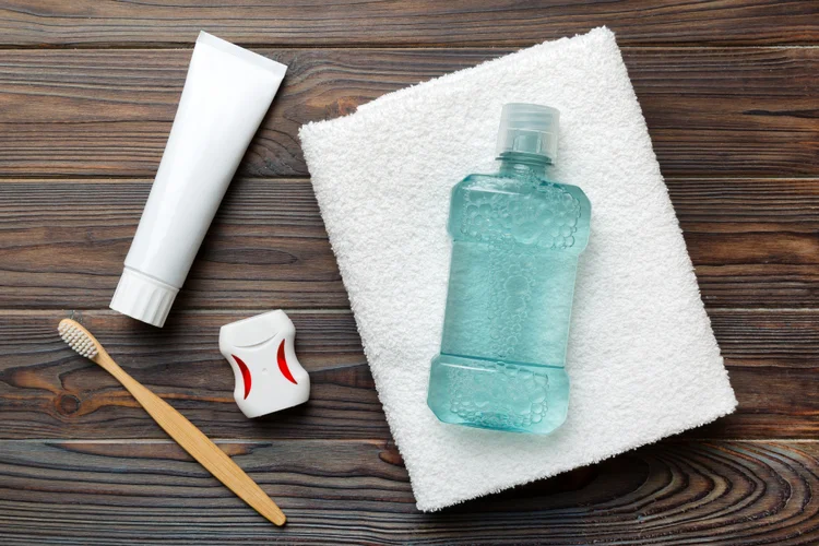 Oral hygiene essentials including toothbrush, toothpaste, floss, and mouthwash for preventing infections and wisdom tooth pain.