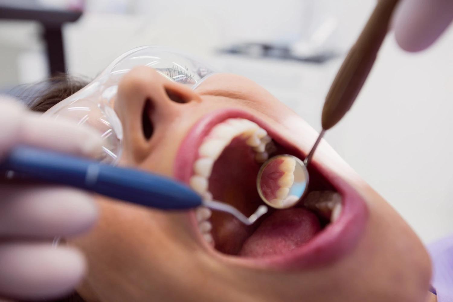 Female patient undergoing Root Canal Treatment procedure at dental clinic.