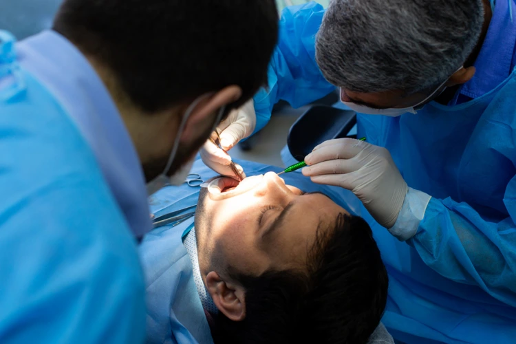 Male patient undergoing tooth extraction procedure.